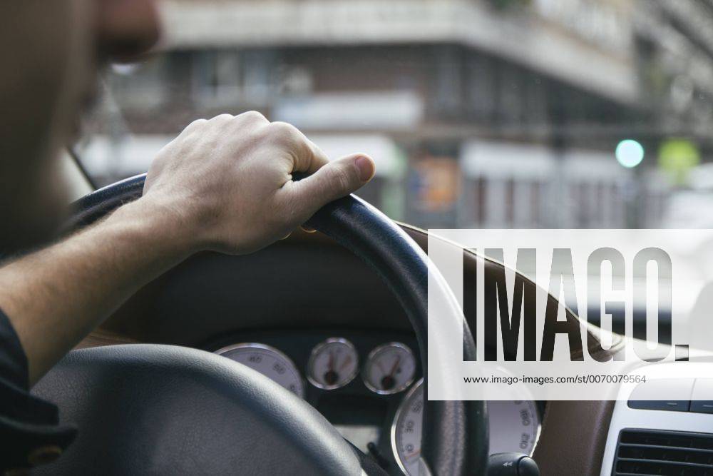Hand of a man driving a car model released Symbolfoto ABZF000272