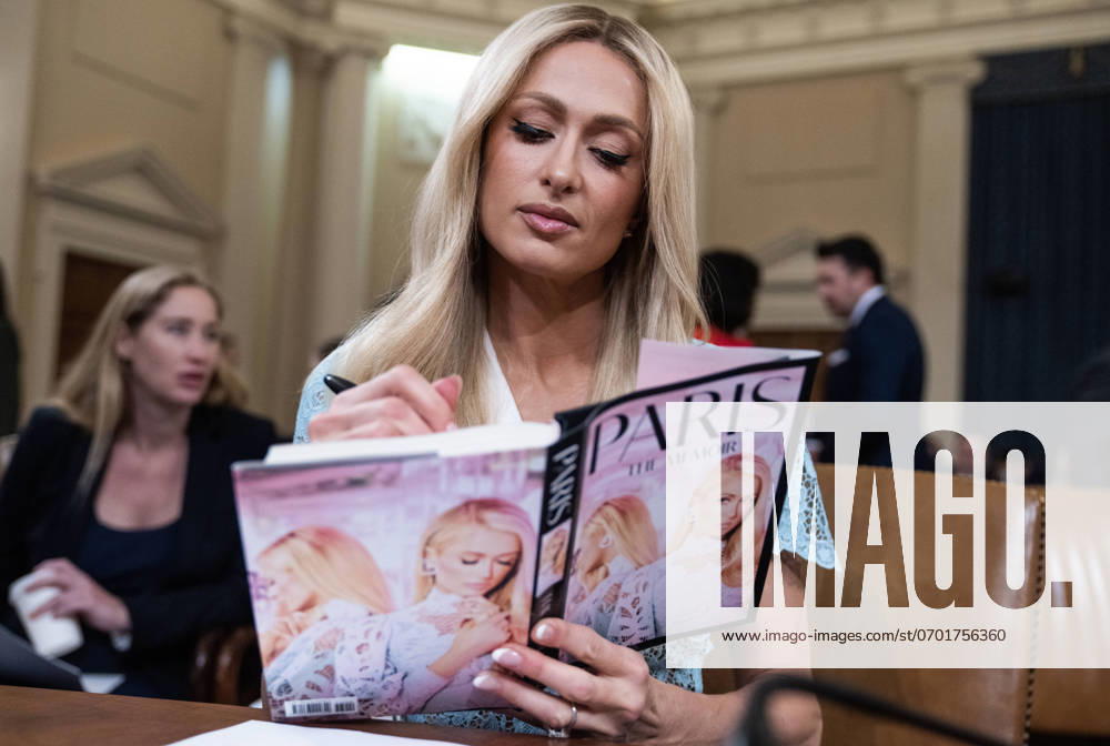 Paris Hilton Ways and Means Committee UNITED STATES - JUNE 26: Paris Hilton, Lived-Experience Advocate and CEO 11:11 Media, signs a copy of her book during a break in the House Ways and Means Committee hearing on Strengthening Child Welfare and Protecting Americas Children, in Longworth building on Wednesday, June 26, 2024. (Tom Williams CQ Roll Call) Bethesda MD United States