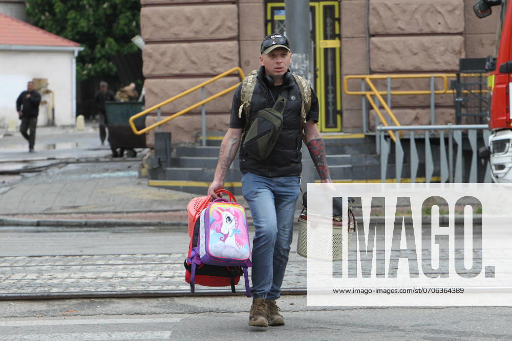 Residential building damaged by Russian shelling in Dnipro DNIPRO, UKRAINE - APRIL 19, 2024 - A local resident carries personal belongings outside the apartment block damaged by the Russian missile attack, Dnipro, eastern Ukraine.,