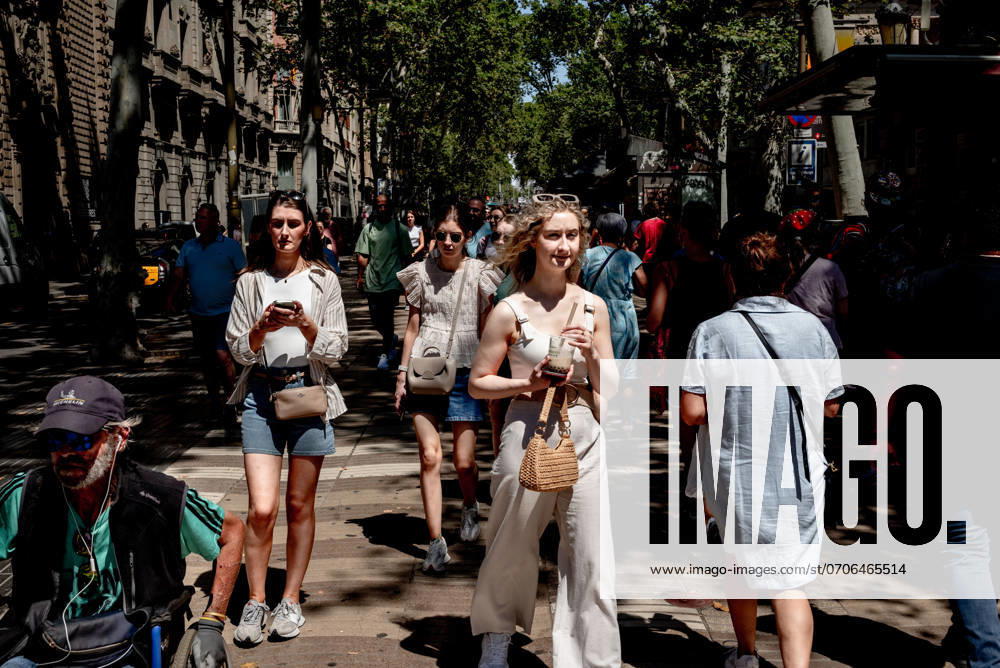 People walk down La Rambla in Barcelona, one of the main boulevards in the world and destination of millions of tourists and passers-by a year. This summer the Catalan capital is on track to break its all-time record for tourist visits. Barcelona Spain - ZUMAb137 20240705_fap_b137_001