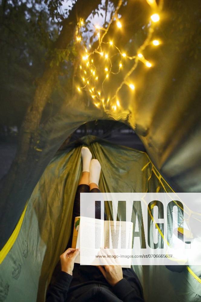 Camping in Night Forest With Sparklers. Woman Lying In Hammock ,model released, Symbolfoto