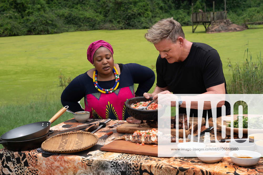 Gordon Ramsay: Uncharted (2019) - filmstill South Africa - Chef Zola Nene (L) observes as Gordon Ramsay tops grilled fish with ushatini, a combination of onions and tomatoes. Gordon Ramsay: Uncharted (2019)