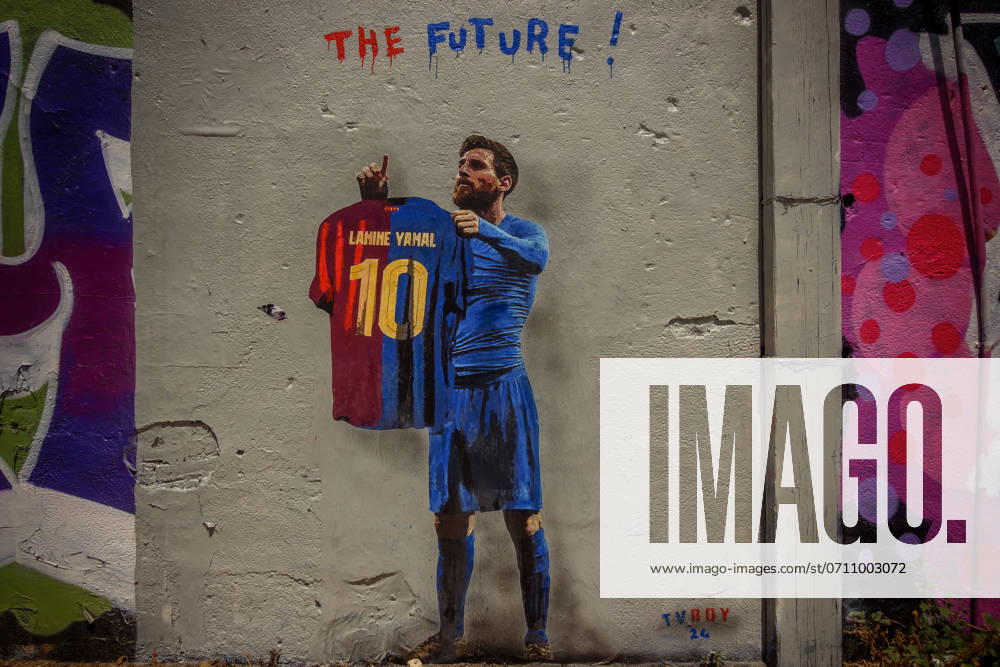 A commuter walks past a mural by Italian urban artist TVBoy , Salvatore Benintende. Titled The Future, the graffiti depicts Lionel Messi holding an FC Barcelona jersey with his former number 10 and the name Lamine Yamal, presenting the young star on the day he could become the youngest winner of a UEFA Euro championship ever, as his successor. Barcelona Spain - ZUMAo105 20240614_fap_o105_015