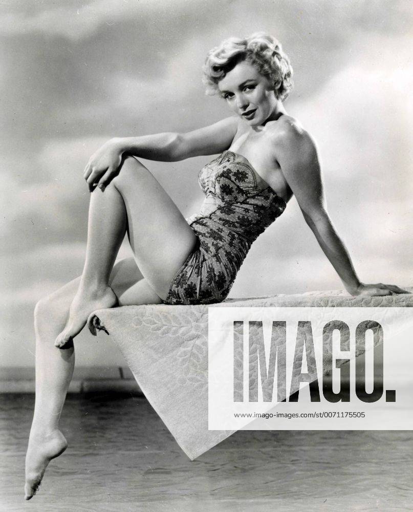 IMAGO ICONS: Marilyn Monroe American actress Marilyn Monroe posing sitting on the trampoline in a swimsuit 02738