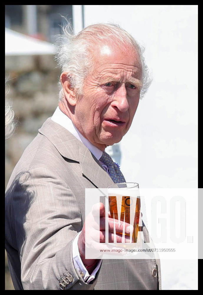 St. Peter Port, United Kingdom. Pictured: His Majesty the King enjoys a drink from BottomÕs UP, a local seafront bar. Their Majesties the King and Queen Visit the Channel Islands. Their Majesties attend a Special Sitting of the States of Deliberation, GuernseyÕs Parliament, taking place on the St Peter Port seafront.