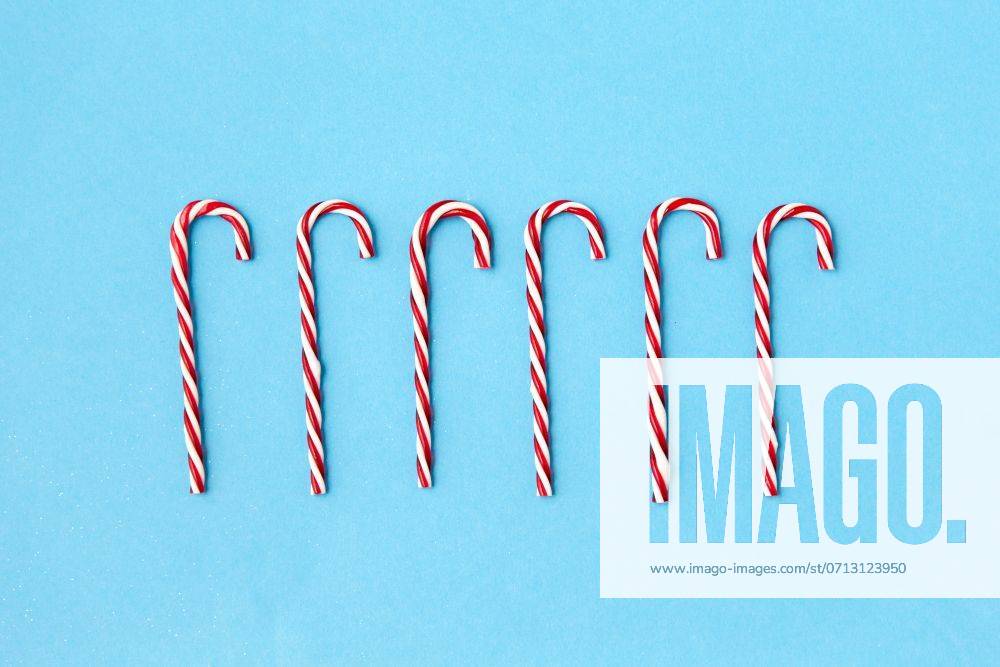 Christmas and winter holidays concept - candy cane decorations on blue background. candy cane decorations on blue background ,model released, Symbolfoto