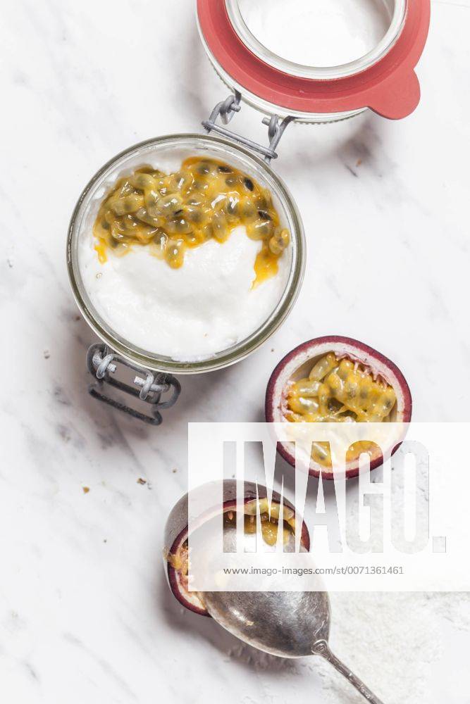 Bowl of vegan coconut yogurt with passion fruit pulp SBDF002793