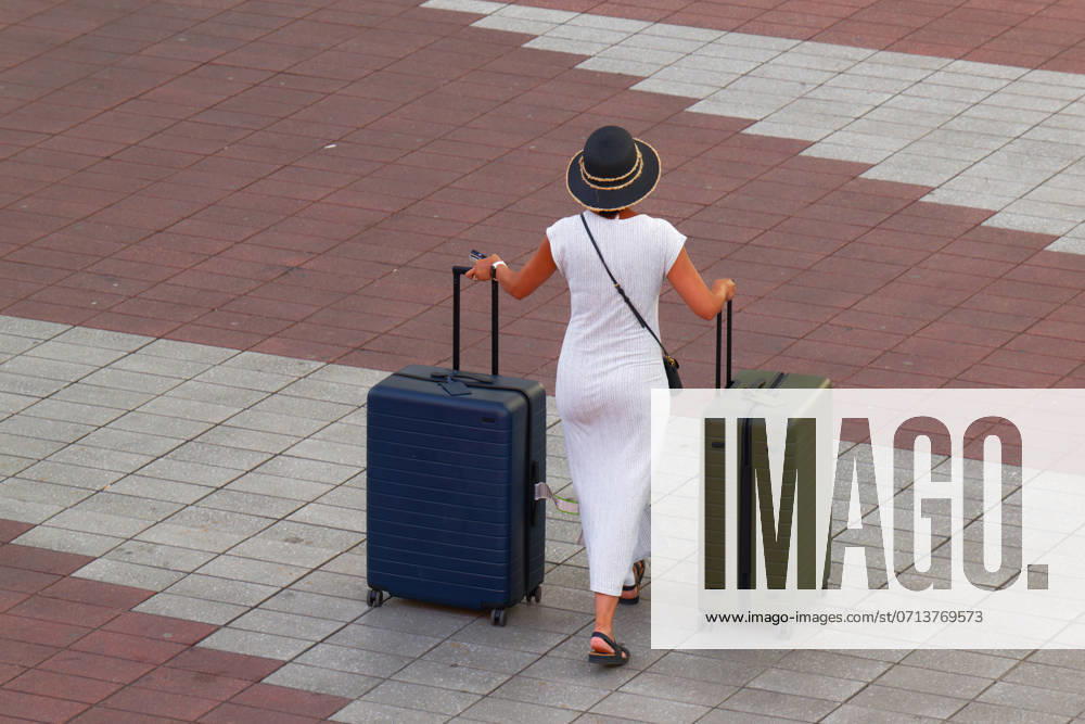 Finally on vacation The woman is on the road with her packed suitcases Munich Bavaria Germany