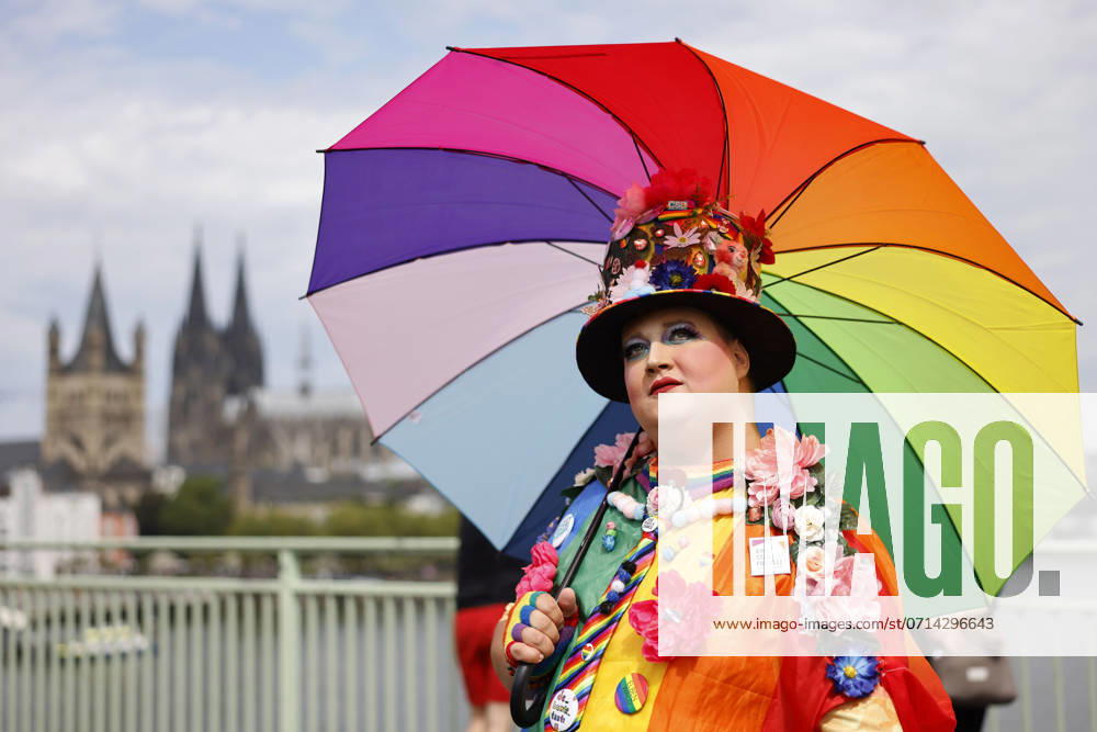 A participant of the demo poses with rainbow outfit in front of Cologne Cathedral at the CSD parade as part of Cologne Pride 2024 Cologne, 21 07 2024 NRW Germany