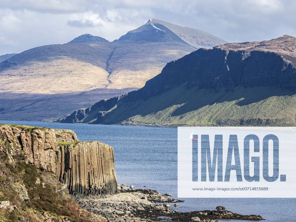 Single Red Sailing boat, Sea between Isle of Ulva and Isle of Gauze, Mt Ben More Mull in The back, Scotland, UK