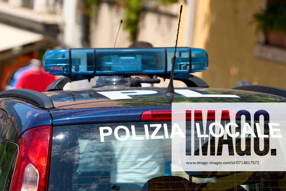 Police vehicle of the Polizia Locale parked in a busy street in Malcesine on Lake Garda, Italy. Symbolic image for the constant presence and surveillance to ensure public safety and order