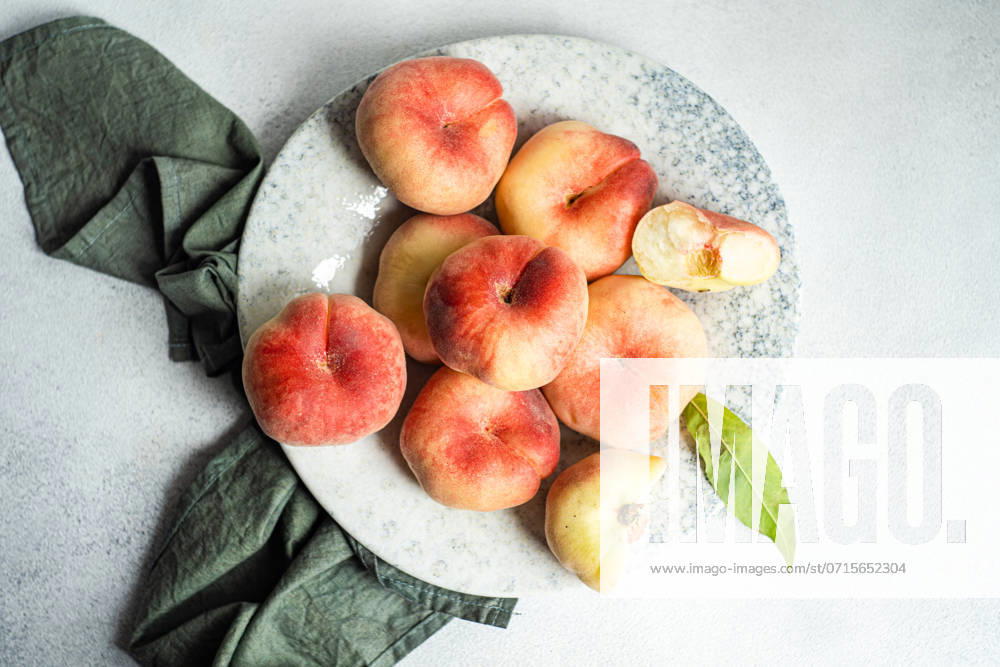 Ripe fresh flat peaches in the bowl Tbilisi, Tbilisi, Georgia R_LSQHTY240722-1492817-01