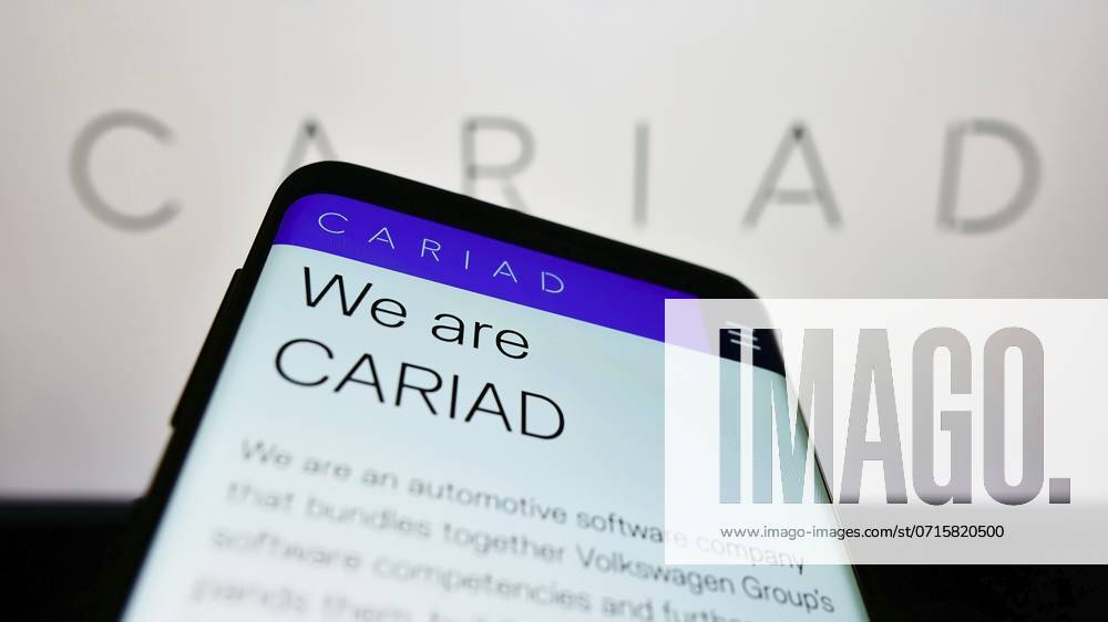 Mobile Phone With Website of German Automotive Software Company Cariad SE ON Screen in Front of Business Logo Focus ON Top left of Phone display, Europe