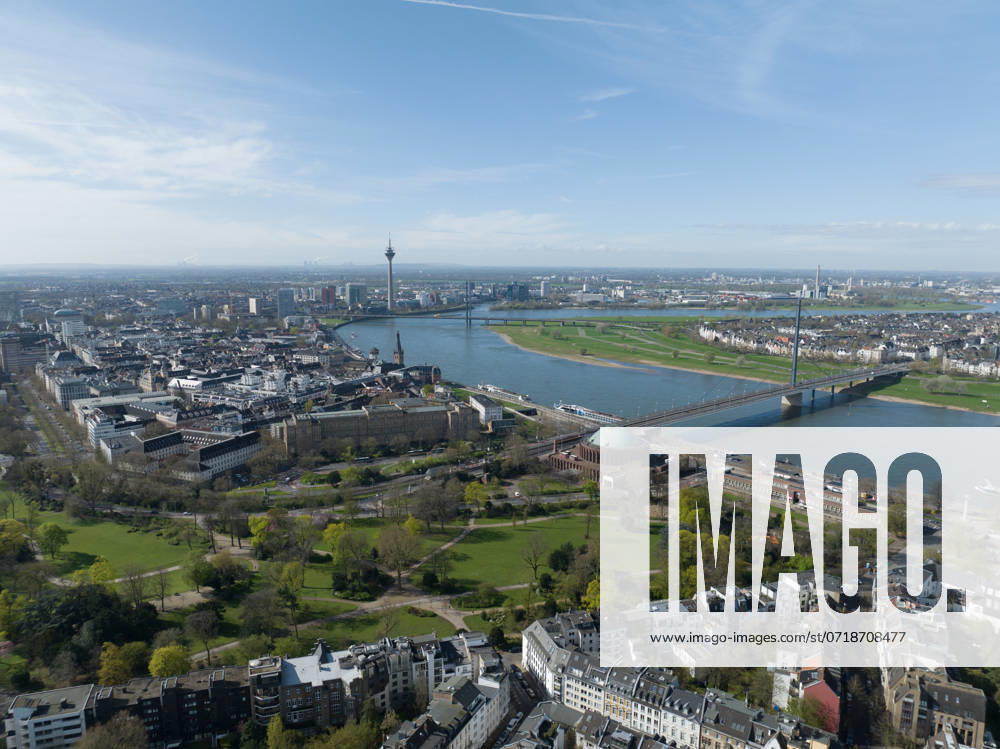 Aerial drone view over Dusseldorf, including the Rhine River and the Oberkasseler Brucke, capturing their scenic and architectural features. Aerial photo. Aerial drone view over Dusseldorf, including the Rhine River and the Oberkasseler Brucke, capturing their scenic and architectural features.