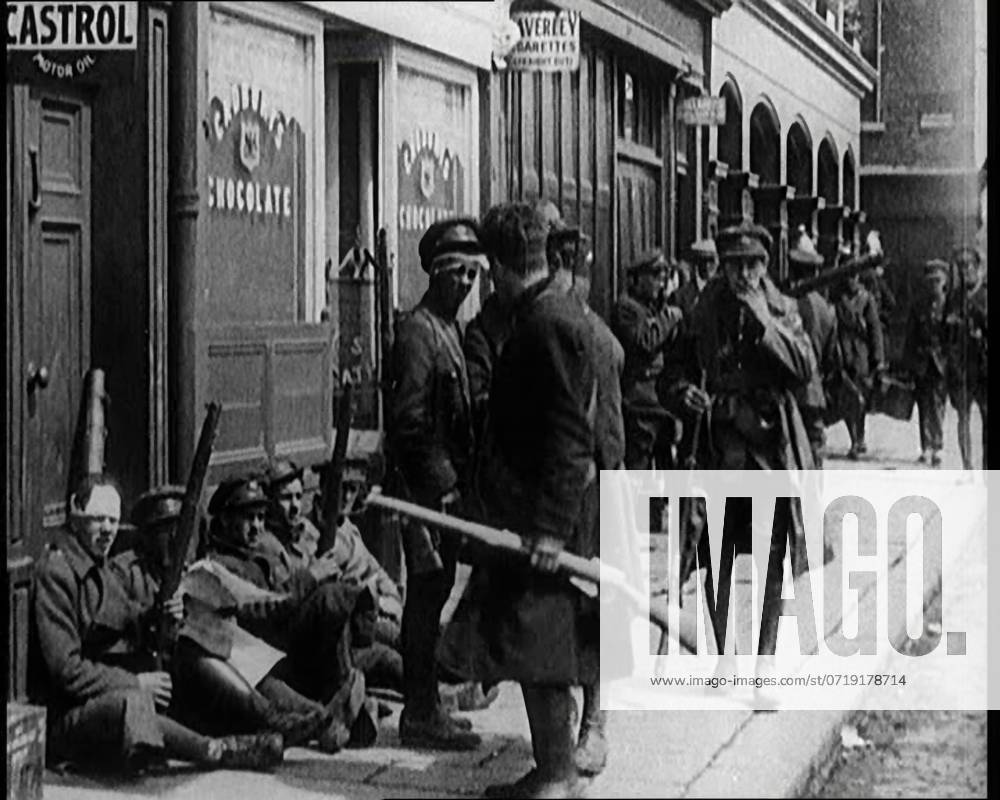 Irish Soldiers Sitting in the Street and Tending to Their Injuries from Fighting in Dublin, 1922. From Time to Remember - Sitting Still And Going Slowly, 1922 (Reel 4); a review of events in 1922 including Irish Troubles, war between Greece and Turkey and developments in aviation and radio.