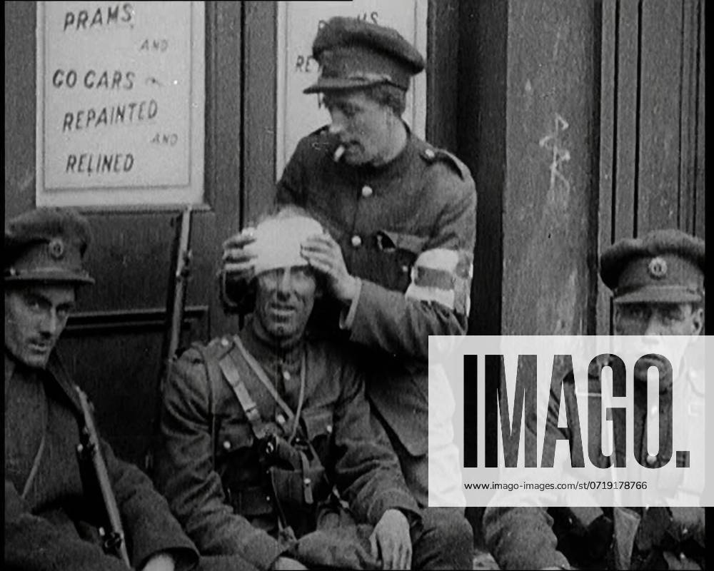 Irish Soldiers Sitting in the Street and Tending to Their Injuries from Fighting in Dublin, 1922. From Time to Remember - Sitting Still And Going Slowly, 1922 (Reel 4); a review of events in 1922 including Irish Troubles, war between Greece and Turkey and developments in aviation and radio.
