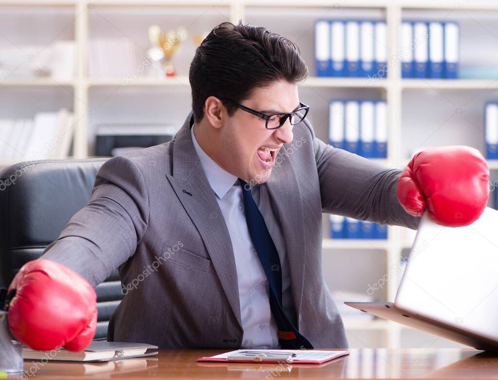 The angry aggressive businessman with boxing gloves