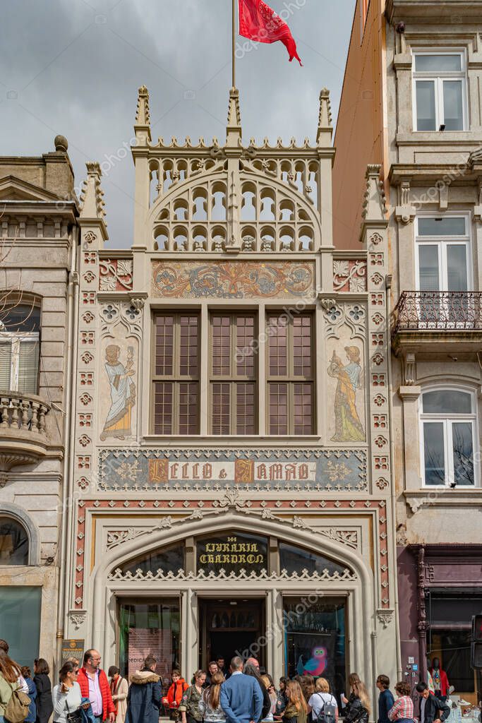 PORTO, PORTUGAL, CIRCA MARCH 2019: Crowds of tourists wait outside in line to visit the famous bookstore of Livraria Lello in historic center of Porto