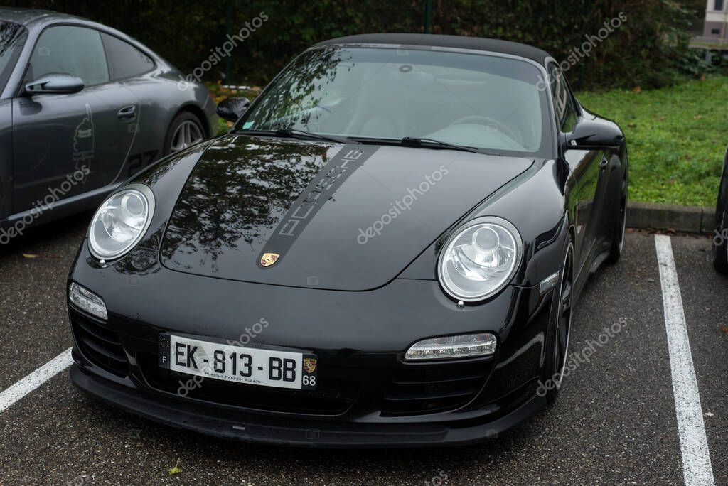 Mulhouse - France - 13 November 2022 - Front view of black Porsche 911 turbo parked in the street
