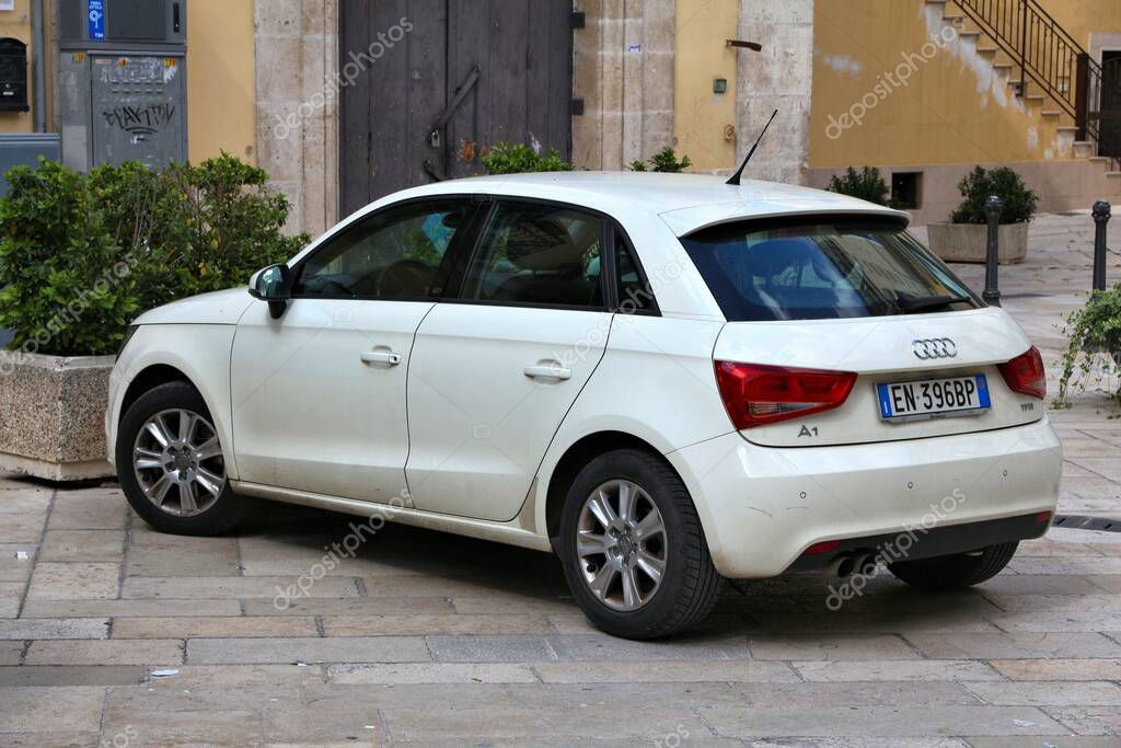 Audi A1 small white hatchback city car parked in Italy. There are 41 million motor vehicles registered in Italy.