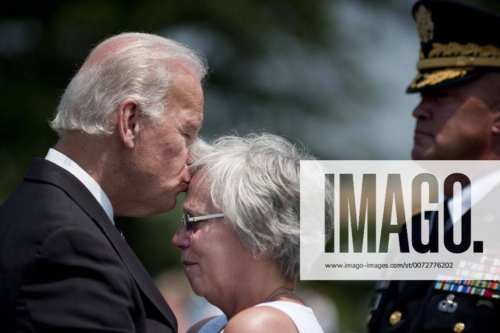 Washington, District of Columbia, U.S., - Vice President Joe Biden kisses the forehead of Susan Van Aalten during a visit to Section 60 of Arlington National Cemetery on Memorial Day. Aalten s son, Sergeant Alexander Van Aalten, 21, of Monterey, Tennessee, was killed April 20, 2007, in Sangin, Afghanistan, of wounds suffered when a land mine detonated near his unit during combat operations. He was assigned to the 1st Battalion, 508th Parachute Infantry Regiment, 4th Brigade Combat Team, 82nd Airborne Division, Fort Bragg, North Carolina. - ZUMAmv2_