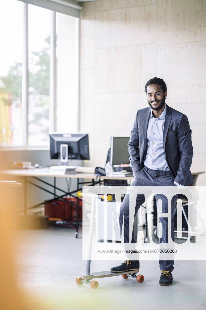 Young businessman with kickboard in office model released Symbolfoto property released RIBF000506