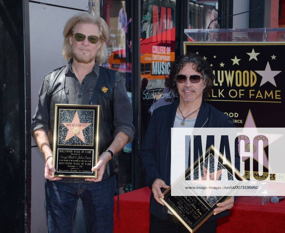 Daryl Hall (L) and John Oates hold replica plaques during an unveiling ceremony honoring the singing duo with the 2,587th star on the Hollywood Walk of Fame in Los Angeles on September 2, 2016. LAP2016090206 JIMxRUYMEN