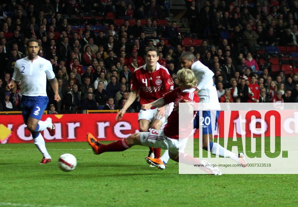 Englands Ashley Young (R) scoring his sides second goal against Simon Kjaer (front) and Daniel Agger (C, Denmark) International Friendly Denmark v England 9th February, 2011 . o0 Tor