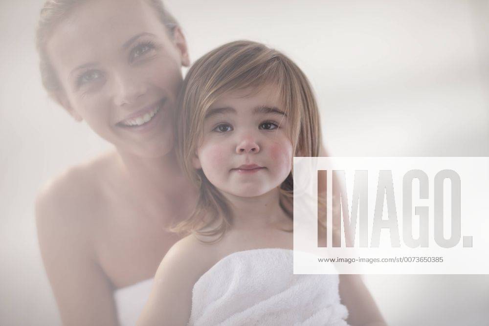 Smiling young woman and little girl wrapped in a towel model released Symbolfoto property released ZEF009606