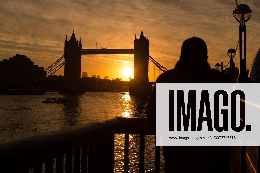 London, London, UK - LONDON, UK. A golden sunrise is seen behind Tower Bridge on the River Thames in London this morning. Sunshine and warm autumn weather are forecast for today. London UK - ZUMAl94_