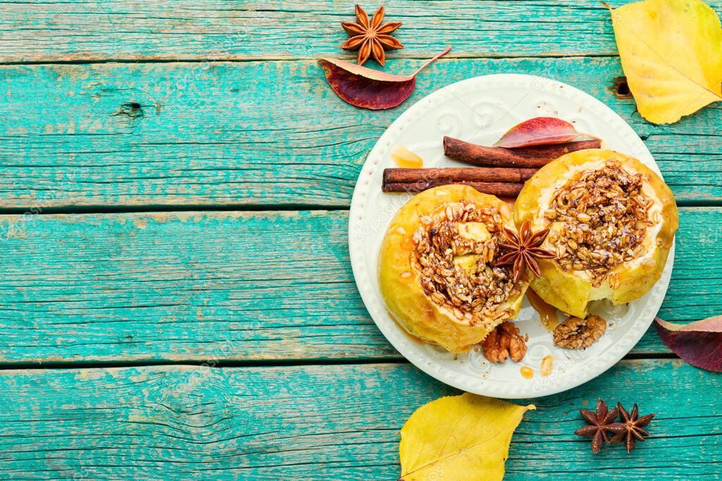 Baked apples stuffed with granola and nuts.Baked apples with nuts.Space for text