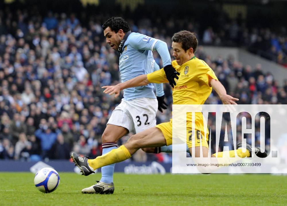 Carlos Tevez of Manchester City (L) holds off the tackle by Jon Harley of Notts County to score the third goal - FA Cup 4th Round replay Manchester City - Notts County - .