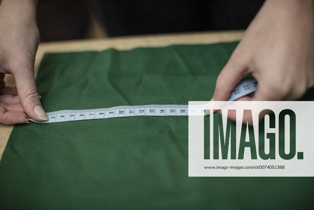 Close-up of woman working with measuring tape in tailor shop model released Symbolfoto property released ZEF10683