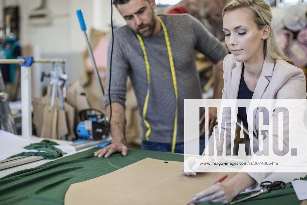 Fashion designer and tailor working together in workshop model released Symbolfoto property released ZEF10662
