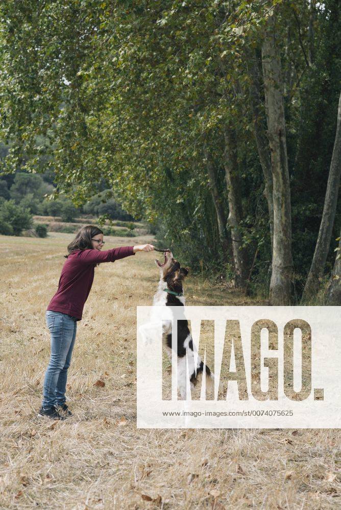 Woman playing with her dog model released Symbolfoto property released SKCF00215