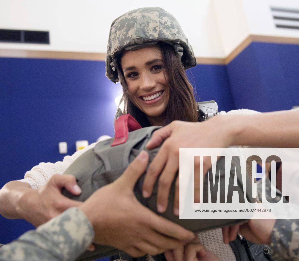 Dec. 7, 2014 - Vicenza, Italy - Actress Meghan Markle is shown how to wear a parachute by the soldiers of the 173rd Airborne Brigade during a holiday visit to service members December 7, 2014 in Vicenza, Italy. The USO tour is for service members deployed outside of the United States during the holidays. Vicenza Italy - ZUMAp138 20141207_zaa_p138_019