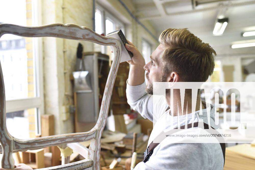Carpenter restoring a wooden chair model released Symbolfoto property released LYF00679