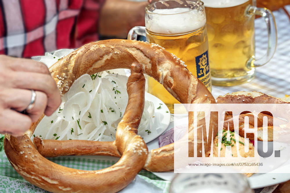 Beer and snack in a Munich beer garden, summer day, Munich, August 2024 Germany, Munich, August 2024, two half beers and a hearty snack in a Bavarian beer garden, Augustiner beer, Obazda with pretzel, plate with radish, typical Bavarian, summer, summer day, drink, enjoy, joie de vivre, Bavaria, Bavarian,