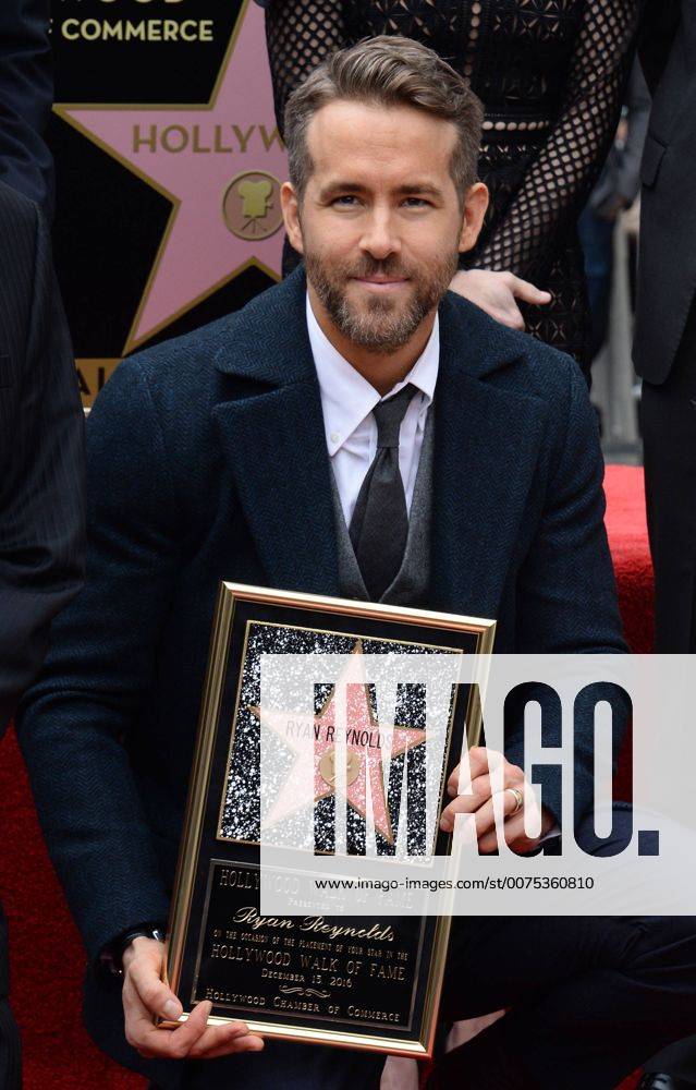 Actor Ryan Reynolds holds a replica plaque during an unveiling ceremony honoring him with the 2,596th star on the Hollywood Walk of fame in Los Angeles on December 15, 2016. LAP2016121517 JIMxRUYMEN