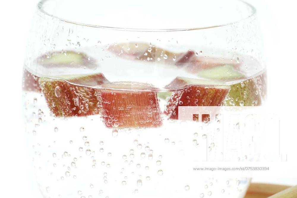 Glass of water with rhubarb pieces over white, Transparent glass filled with cold water and several pieces of rhubarb isolated on white background, Transparent glass filled with cold water and several pieces of rhubarb isolated on white background, 20.03.2024,