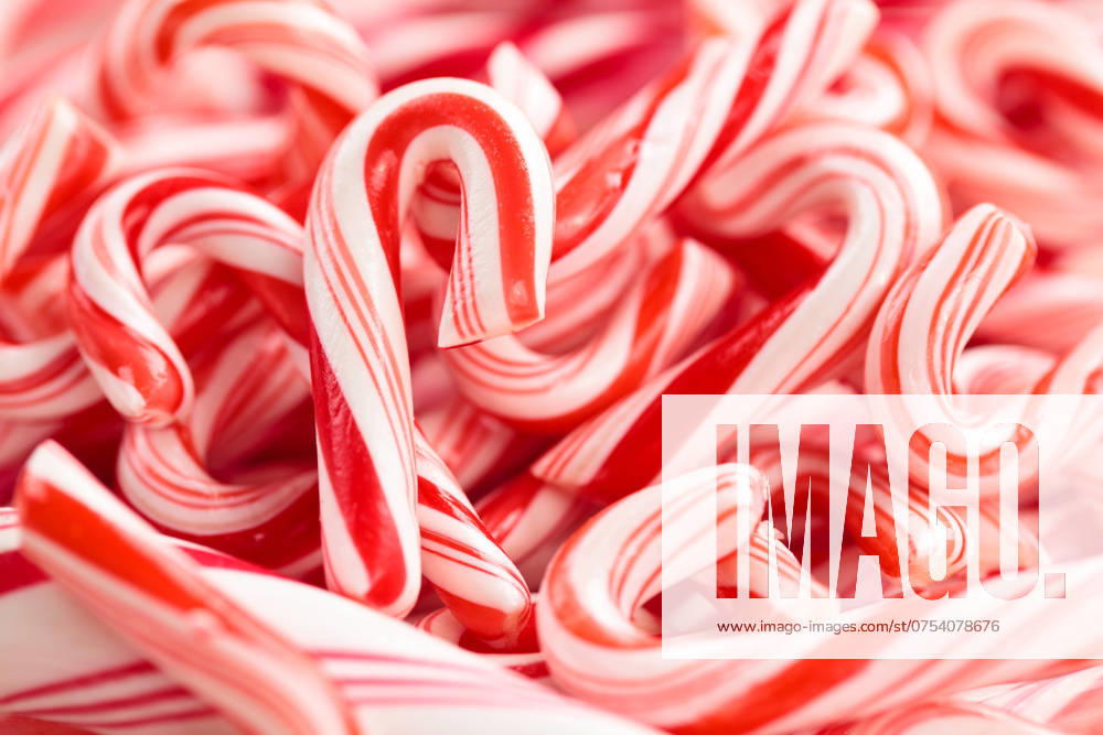 Candy Cane Background. Festive red and white peppermint candycanes background. Shallow dof.