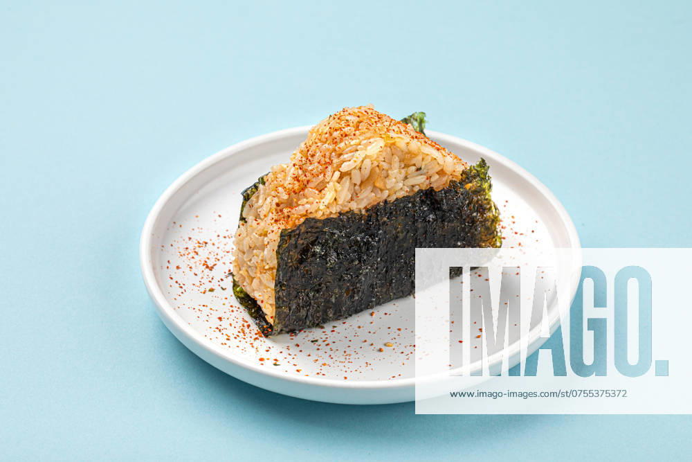 Portion of japanese onigiri snack with spices Portion of japanese onigiri snack with spices on a plate