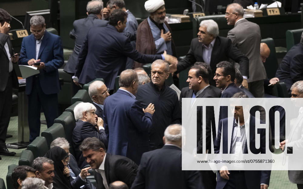Iran Parliament Iranian lawmakers are speaking with Iran s new President, Masoud Pezeshkian (C), while he is attending a session for examining the qualifications of the ministers proposed by President Pezeshkian in the public hall of the Iranian parliament in Tehran, Iran, on August 20, 2024. Tehran Tehran Iran