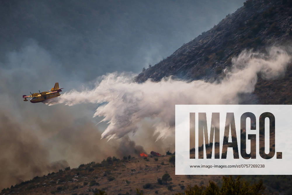 Croatian Firefighting Plane In Action Croatian Firefighting plane drops water on a large fire at village Srinjine near Split, Croatia on August 27, 2024. ZvonimirxBarisin PIXSELL