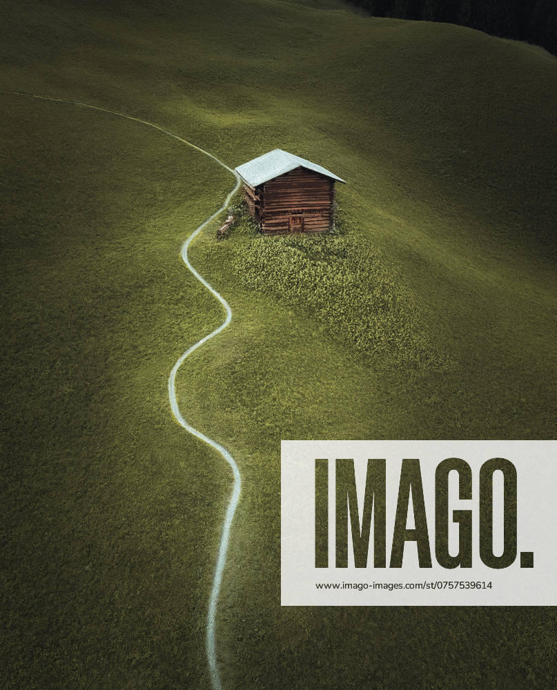 A cozy wooden cabin secluded in the Swiss Alps, accessible by a winding path through a lush green meadow. Model Released Ca_maraphy_ID23343_678643_005