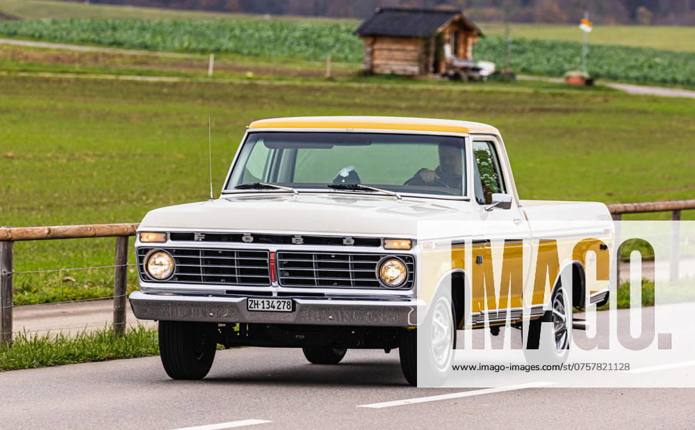 Ford F 100 A Ford F 100, which was built in the period 1973 1980 drives on a road out of town in the canton of Zurich Oberglatt, Switzerland