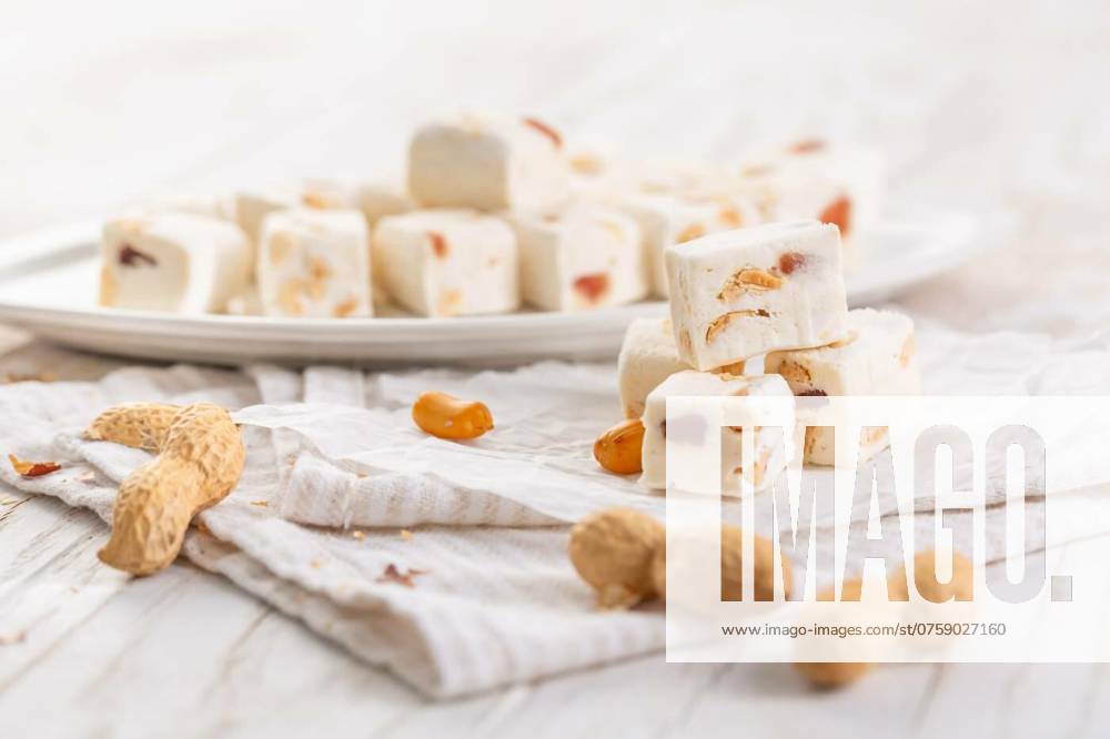 Soft nougat with peanuts on a plate, chewy sweets with nuts, Soft nougat with peanuts on a plate, chewy sweets with nuts, Soft nougat with peanuts on a plate, chewy sweets with nuts, 20.07.2024,