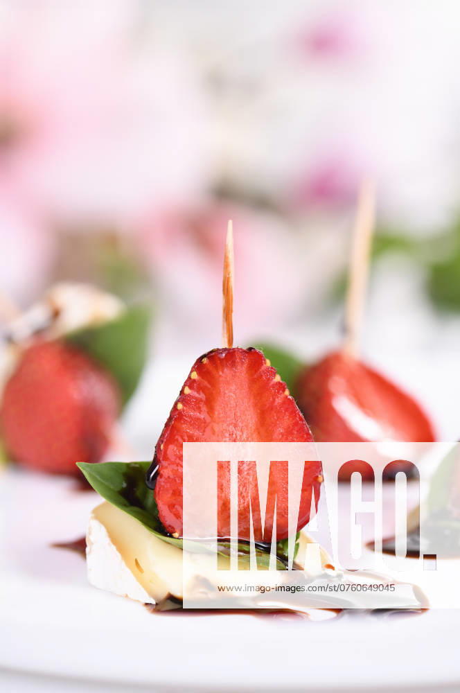 Brie snacks with strawberries and basil Strawberries, cheese, fresh basil and balsamic come together for a bite-sized appetizer