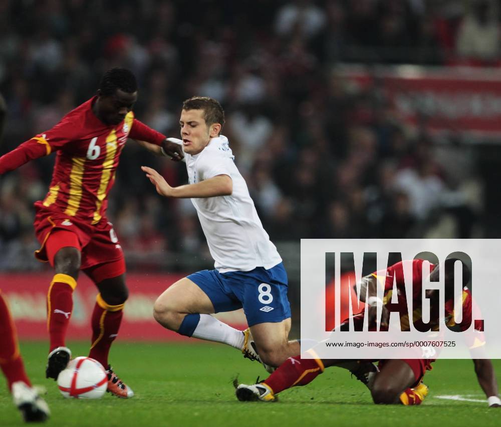 Jack Wilshere of England gets tackled by Emmanuel Agyemang-Badu of Ghana (R) - Friendly England (white) v Ghana 29th March, 2011 .