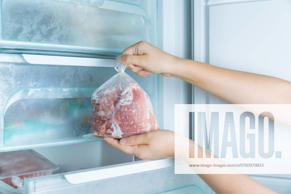 Entnahme von Gefrierfleisch aus dem modernen No Frost Gefrierschrank Taking frozen meat from the modern no-frost freezer